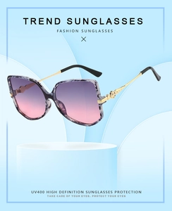 Detail view of butterfly frame sunglasses with gradient lenses and UV400 protection