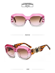 Detail of gradient pink-grey sunglasses with leopard print arms and gold accents