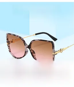 Detail of tortoiseshell square sunglasses with gradient lenses and gold metallic temples