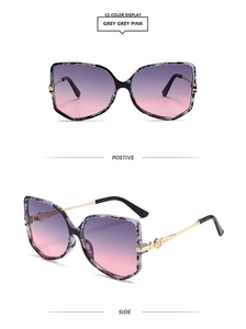 Detail of square butterfly cat-eye sunglasses with purple gradient lenses and gold temples