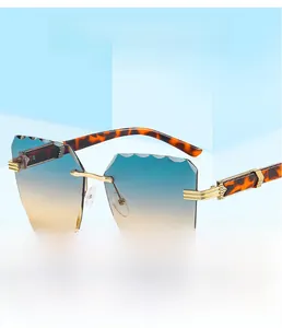 Detail of frameless sunglasses with gradient lenses and leopard print temples