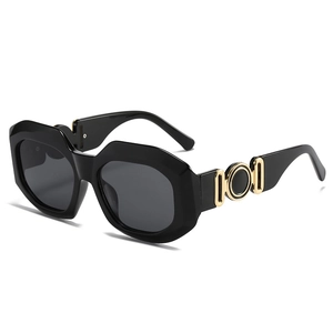 Modern oversized geometric black sunglasses with luxury gold metal hardware details