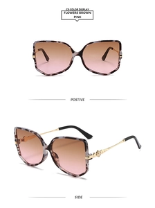 Detail of butterfly frame sunglasses with floral pattern and gold filigree temples