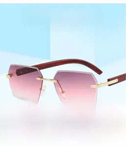 Detail of rimless hexagonal sunglasses with pink gradient lenses and wood texture temples