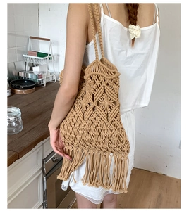 Detail of hand-woven tote bag showing bohemian cotton fringe and hollow diamond pattern