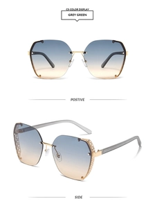 Detail view showing golden metal bridge and gradient grey-green lenses with side mesh mesh