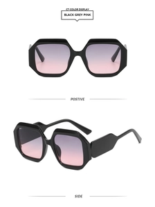 Detail view of black geometric sunglasses with purple pink gradient lenses and thick frames
