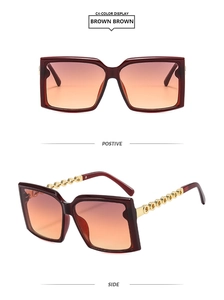 Detail of square oversized brown gradient sunglasses with gold chain temples on white background
