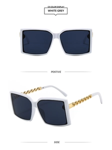 Detailed view of white square sunglasses featuring gold metal interlocking chain temples