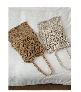 Detail of bohemian handmade cotton woven tote with tassel fringes and thin shoulder straps