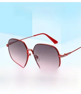 Detail of red oversized square sunglasses with gradient lenses and luxury metal accents