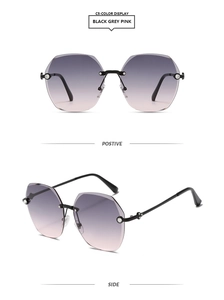 Detail of rimless gradient pink sunglasses with rhinestone trim and polygon cut edges