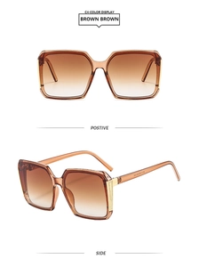 Detail view of brown square sunglasses with gradient lenses and gold temple accents