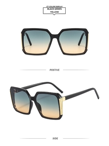 Detail view of square sunglasses showing black frames and gradient blue to orange lenses