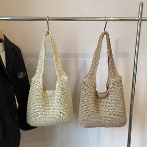 Handwoven straw tote bags in beige and brown colors for summer beach vacations