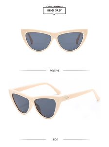 Detail view of beige cat eye sunglasses with grey lenses and subtle metal accents