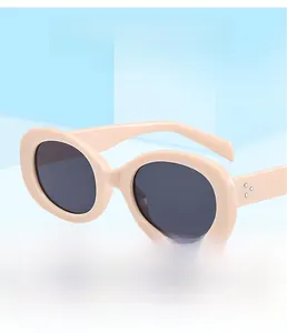 Detailed close-up of retro oval sunglasses featuring silver triple-dot metal rivets