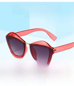 Detail of red cat eye sunglasses with purple gradient lenses and metal bridge accents