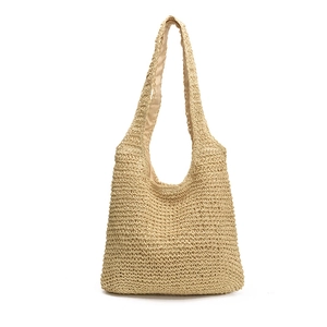 Large hand-woven straw beach tote bag with long shoulder straps and soft fabric lining