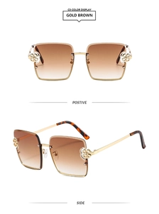 Détail de lunettes de soleil carrées dorées avec verres dégradés et décor floral