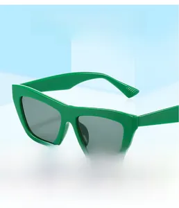 Detail view of stylish green thick cat eye sunglasses with grey lenses and waterproof finish
