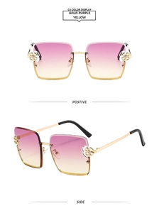 Détail de lunettes de soleil carrées avec charnière fleurie dorée et verres dégradés
