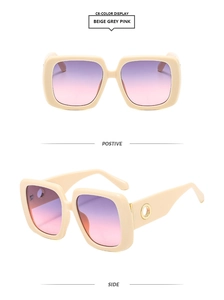 Detail of square beige frames with purple-pink gradient lenses and gold temple accents