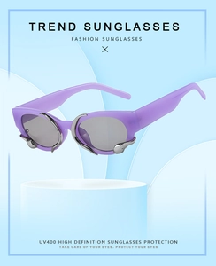 Detail of purple oval sunglasses with silver claw accents and UV400 grey lenses
