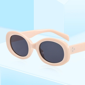 Retro oval thick-frame beige sunglasses with silver rivet accents and dark lenses