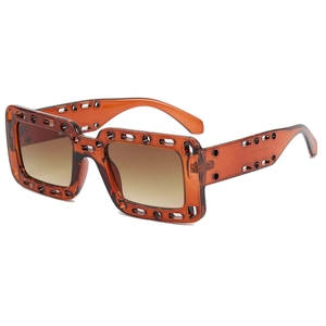 Modern square hollow-out sunglasses in transparent amber brown with gradient lenses