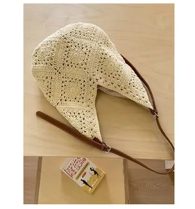 Detail of hollow-out crochet granny square tote bag with adjustable brown leather strap