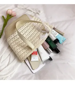 Detailed view of spacious lace-woven straw bag interior filled with personal beauty items