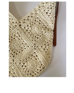 Close-up of cream cotton rope woven texture and brown leather strap on sunflower tote