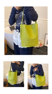 Detail of laser-cut geometric pattern on bright lime green leather bucket bag