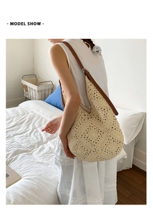 Model wearing a large cream crochet tote bag with brown leather straps for beach holidays