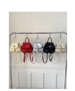 Detailed view of quilted leather backpacks in cream, red, silver, black, and beige colors