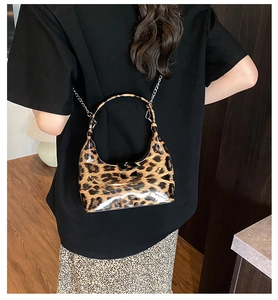 Crossbody leopard print hobo bag with glossy finish and delicate silver chain strap