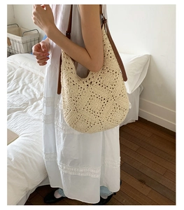Detail of crochet sunflower tote bag with cream floral knit and brown leather strap