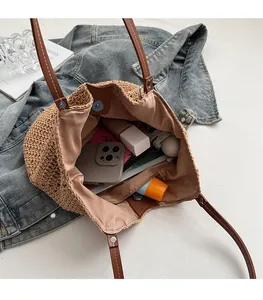 Macro view of woven tote bag interior capacity with leather straps and fabric lining