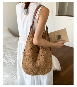 Close-up of a hollow crochet sunflower tote bag with premium brown leather straps