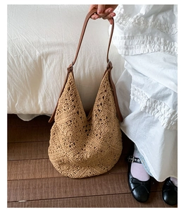 Detailed view of hollow crochet pattern and brown leather straps on the sunflower woven bag
