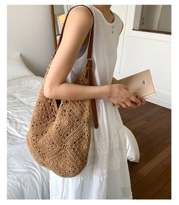 Detail of sunflower crochet bag with hollow knit pattern and adjustable brown strap
