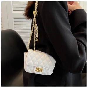 Detail of white quilted leather bag with gold ball adjuster and metal chain strap