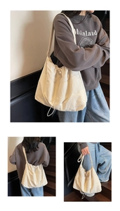Detail view of cream nylon bucket bag showing drawstring closure and waffle texture fabric