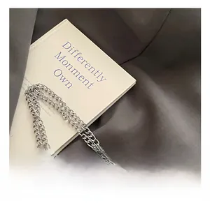 Close-up of leopard print handle and silver chunky metal chain on retro handbag