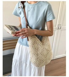 Detail of hollow crochet tote bag featuring premium off-white weave and brown leather strap