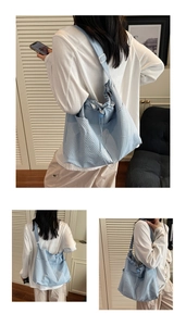 Detail of light blue waffle textured canvas tote bag with adjustable drawstring closure