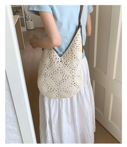 Detail of hand-woven hollow knit tote bag with premium brown leather shoulder strap