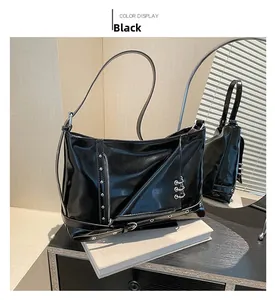 Détail d'un sac punk en cuir verni noir avec anneaux métalliques et rivets argentés