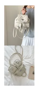 Detailed macro view of cream quilted backpack with drawstring closure and metal buckles